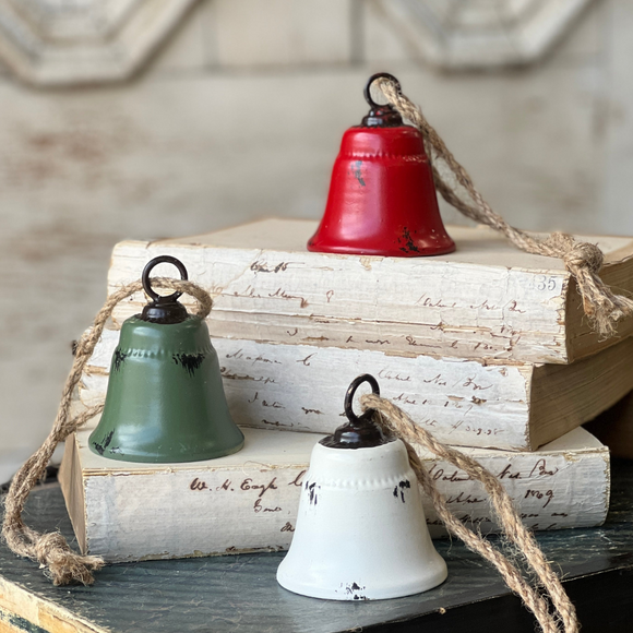 Set of three distressed bells on burlap rope in red green and cream
