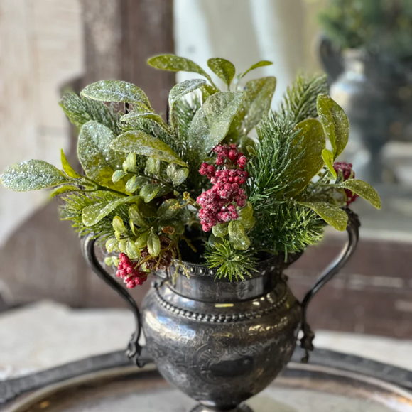 Green leaves and berries in a pedestal container