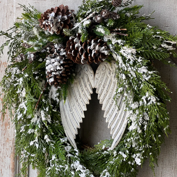 Icy wreath with pine cones and angel wings