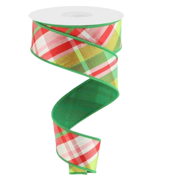 Roll of ribbon with diagonal plaid stripes in pink, green and white with solid green background