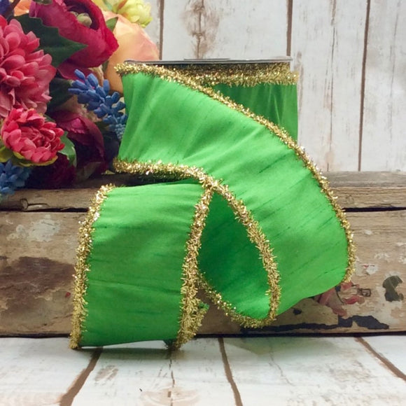 Roll of green ribbon with gold tinsel edges