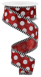 Roll of ribbon with white polka dots on red background with black and white striped edges