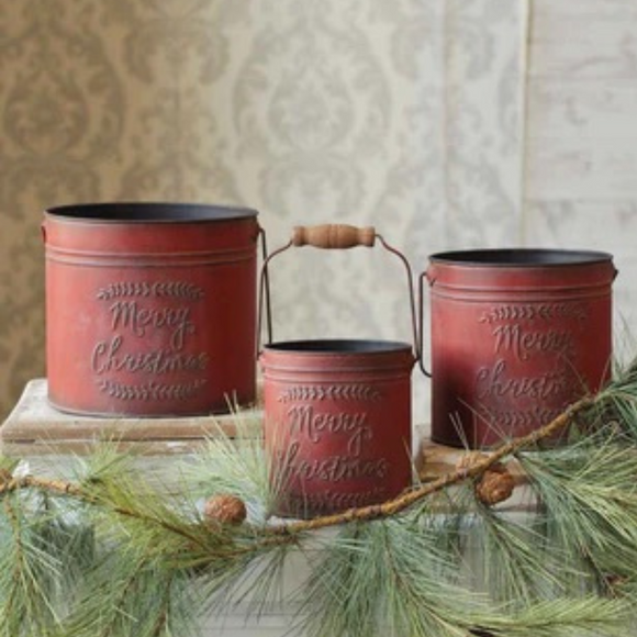 Set of three red colored buckets that say merry christmas