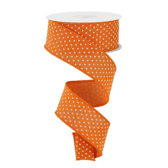 Roll of orange ribbon with white polka dots