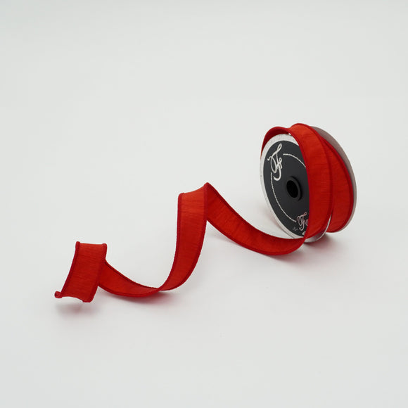 Roll of silk ribbon in red