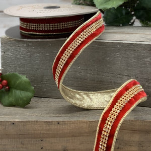 Roll of red velvet ribbon wth a rhinestone center and gold back