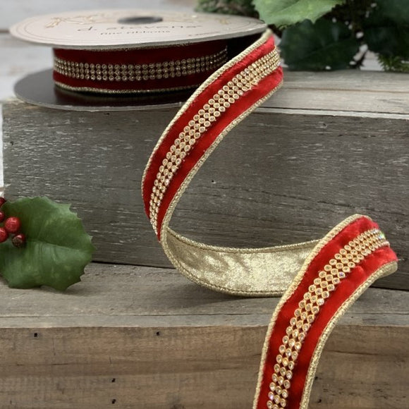 Roll of red velvet ribbon wth a rhinestone center and gold back