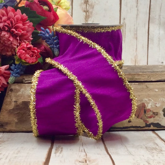 Roll of purple ribbon with gold tinsel edges